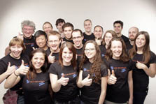 Photo of eighteen members of Team Alberta wearing matching team t-shirts and giving thumbs-up signs.