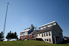 Photo of the University of Massachusetts Dartmouth house and wind turbine on the McKechnie property.