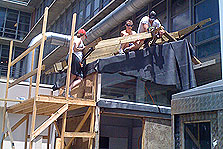 Photo of students working on the roof of the research model that uses parts of their Solar Decathlon 2007 house.